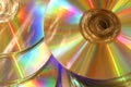 Glowing golden rainbow compact disks Royalty Free Stock Photo