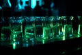 Glowing green chemicals in test tubes in dark chemistry lab. Scientist laboratory equipment. Generative AI