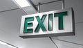 Illuminated Green Exit Sign on a Monochrome Background Royalty Free Stock Photo