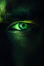 Glowing green eye of a mysterious man. Serious expression. Royalty Free Stock Photo
