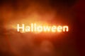 Glowing Halloween text burning red smoke