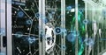 Glowing holographic network nodes connecting server cabinets at data center, with LED indicators Royalty Free Stock Photo