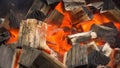 Glowing Hot Charcoal In BBQ Grill Pit With Flames, Close-up. Burning coals close up Royalty Free Stock Photo