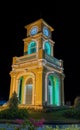 Glowing and illuminated Clock tower on a roundabout in old phuket town at night phuket thailand.