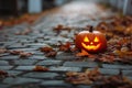 Glowing Jack-o-Lantern on Leaf-Strewn Pathway in Autumn Evening Light. Royalty Free Stock Photo