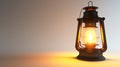 Glowing kerosene lantern on a warm toned background
