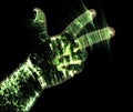 Glowing kirlian aura photography with green corona of a male human hand