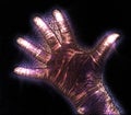 Glowing kirlian coronal aura photography with blue and purple colors of a male human hand Royalty Free Stock Photo