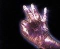 Glowing kirlian coronal aura photography with blue and purple colors of a male human hand Royalty Free Stock Photo