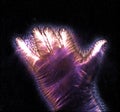 Glowing kirlian coronal aura photography with blue and purple colors of a male human hand Royalty Free Stock Photo