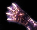 Glowing kirlian coronal aura photography with blue and purple colors of a male human hand Royalty Free Stock Photo