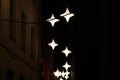 Glowing lanterns in the form of stars on the narrowest street in Riga - Rosen Street, Latvia