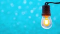 Glowing light bulb against a blue background. Concept of illumination and creativity Royalty Free Stock Photo