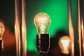glowing light bulb against green wall background Royalty Free Stock Photo
