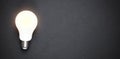 Glowing light bulb in the black background Royalty Free Stock Photo