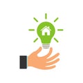 Glowing light bulb in a businessman\'s hand. Environmental light bulb with a house logo. Eco world, house, energy saving lamp Royalty Free Stock Photo