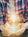 Glowing light bulb icon on smartphone. to get Business , earning money, knowledge, learning, leadership, idea, innovation and crea Royalty Free Stock Photo