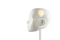 Glowing light bulb inside a head of a white mannequin doll, concept for ideas, mind, insight, realization and creativity, isolated