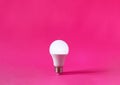 Glowing light bulb on magenta background. Discovery, invention, new idea concept Royalty Free Stock Photo