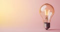 Glowing light bulb on pink and yellow background Royalty Free Stock Photo