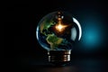 Glowing light bulb with planet earth inside. Global energy crisis in world. Blackout concept Royalty Free Stock Photo