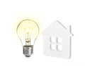 Glowing light bulb and small model of house on background. Energy efficiency, loan, property or business idea concepts Royalty Free Stock Photo