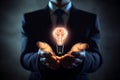 Glowing light bulb with smart brain inside on businessman hands, brainstorming new ideas with creativity and innovation technology Royalty Free Stock Photo