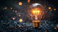 Illuminated light bulb with sparkling bokeh on a dark surface Royalty Free Stock Photo