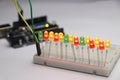 Glowing light emitting diode in short LED which is an Electronic component connected to breadboard with some micro controller on