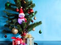 The glowing light snowman doll with part of The Artificial Christmas tree. Royalty Free Stock Photo