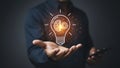 Glowing lightbulb with brain and gear inside hovering above cupped hands, symbolizing innovation and technology Royalty Free Stock Photo