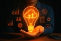 Glowing lightbulb with cloud upload icon representing cloud technology innovation and digital business growth Royalty Free Stock Photo