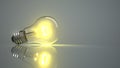 Glowing Lightbulb Grey Background Royalty Free Stock Photo