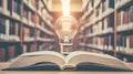 Glowing Lightbulb on Open Book in Library, Good Resolution Stock Photo Royalty Free Stock Photo