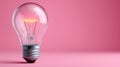 A glowing lightbulb on a pink background, symbolizing ideas. Royalty Free Stock Photo