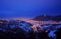 Glowing lights of the night city of Brasov in Romania, panorama. Royalty Free Stock Photo