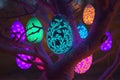 Glowing luminescent easter eggs hanging on a tree in the garden. Generative AI