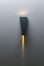 A glowing modern aluminum led lamp on the gray wall