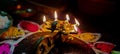 A glowing Multi Flame Lamp commonly known as Panchapradip. A holy thing used as an offering to God for worship. Surrounded by