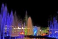A glowing musical fountain at night. Splashes of colored water Royalty Free Stock Photo
