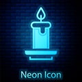 Glowing neon Aroma candle icon isolated on brick wall background. Vector