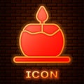 Glowing neon Aroma candle icon isolated on brick wall background. Vector