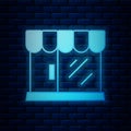 Glowing neon Barbershop building icon isolated on brick wall background. Vector