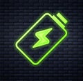 Glowing neon Battery charge level indicator icon isolated on brick wall background. Vector Royalty Free Stock Photo