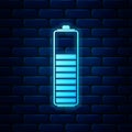 Glowing neon Battery charge level indicator icon isolated on brick wall background. Vector