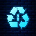 Glowing neon Battery with recycle symbol icon isolated on brick wall background. Battery with recycling symbol -