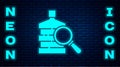 Glowing neon Big bottle with clean water and magnifying glass icon isolated on brick wall background. Plastic container Royalty Free Stock Photo