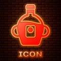 Glowing neon Bottle of maple syrup icon isolated on brick wall background. Vector