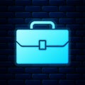 Glowing neon Briefcase icon isolated on brick wall background. Business case sign. Business portfolio