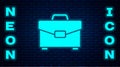 Glowing neon Briefcase icon isolated on brick wall background. Business case sign. Business portfolio. Vector